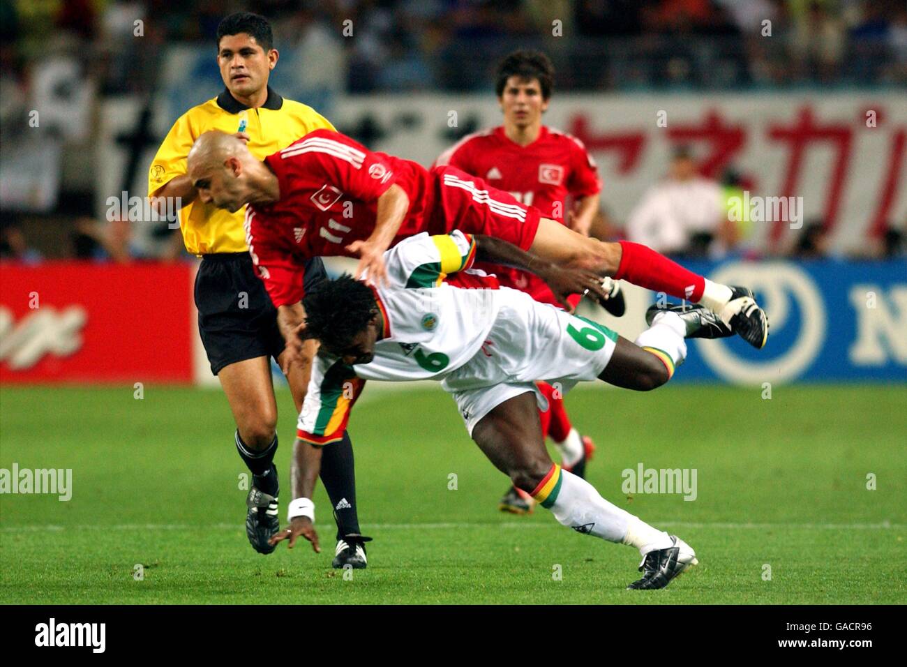 Turkey's Hasan Sas and Senegal's Aliou go over under the watchfull eye of referee Oscar Ruiz Stock Photo