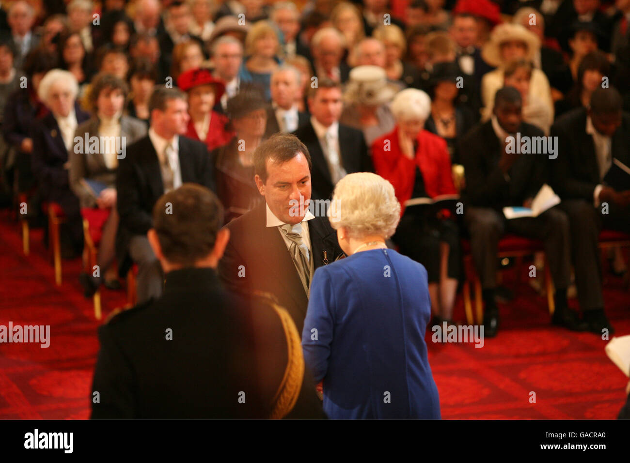 Mr. David Westwood, from Windsor, is made an MVO by The Queen at Buckingham Palace. Stock Photo