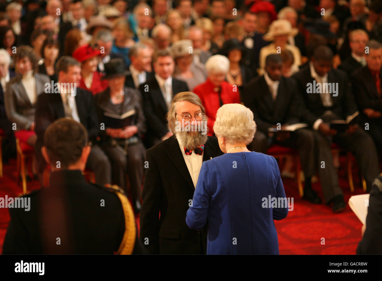 Mr. Desmond Pawson, from Ipswich, is made an MBE by The Queen at Buckingham Palace. Stock Photo