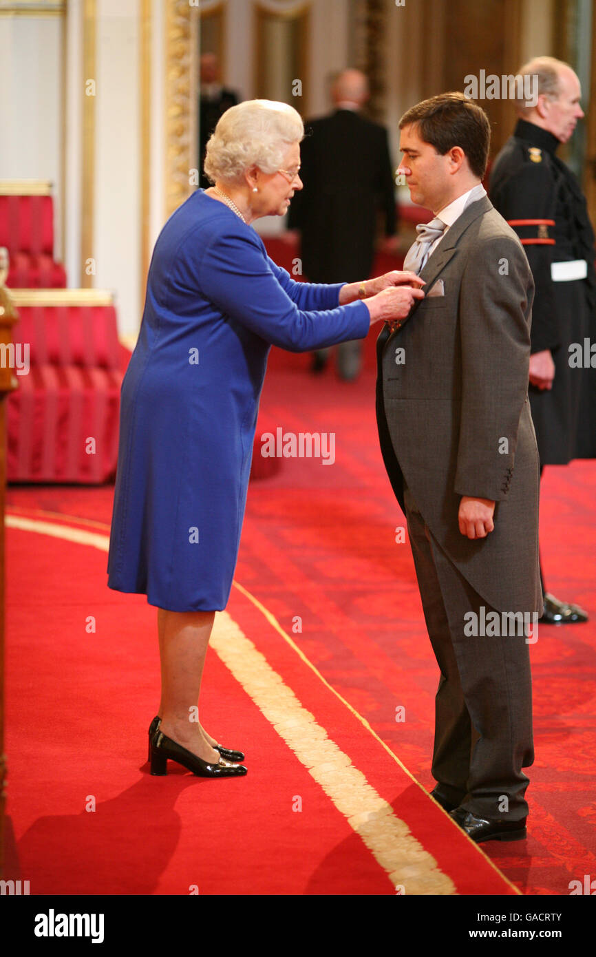 Mr. Dominic Meiklejohn is made an OBE by The Queen at Buckingham Palace. Stock Photo