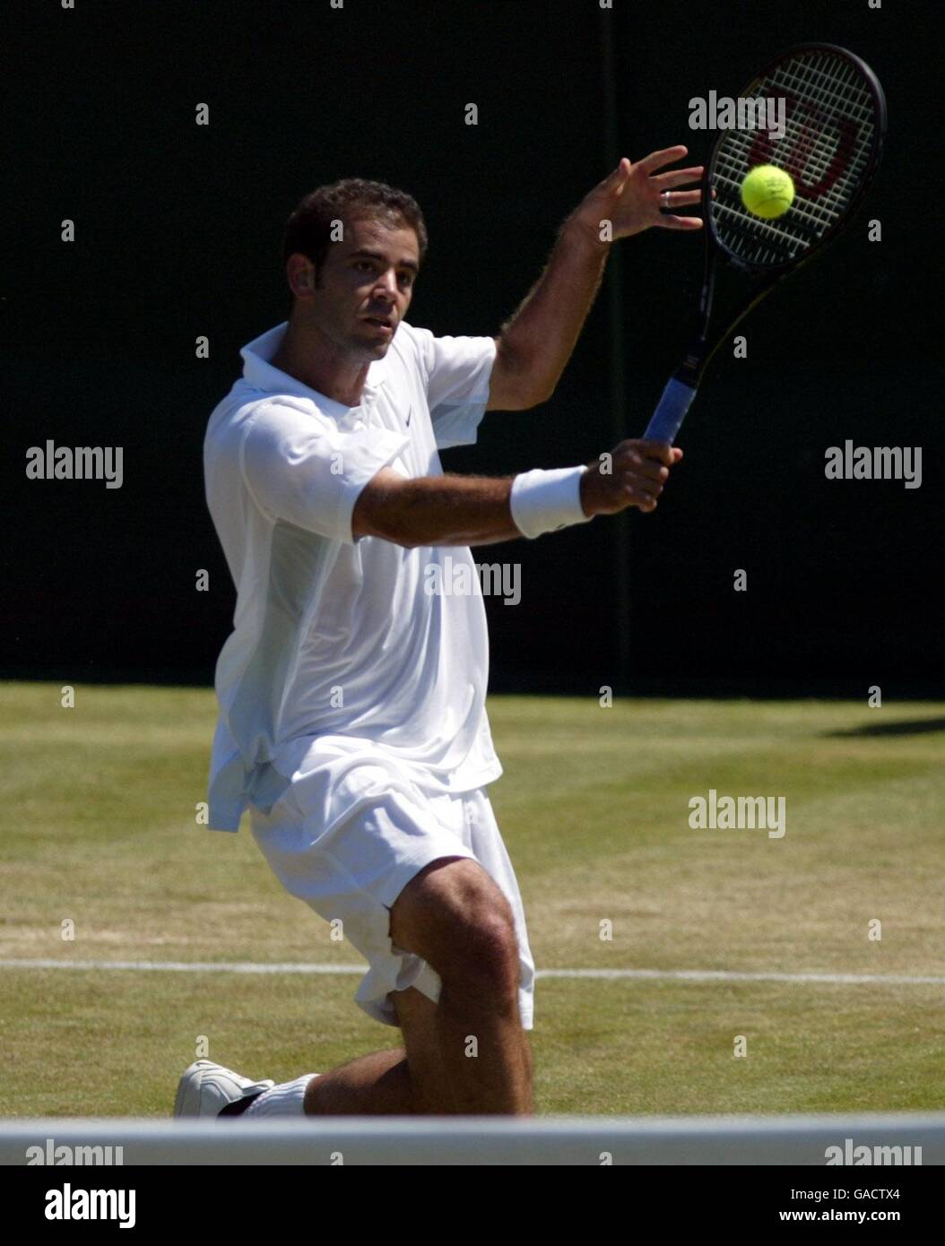 Pete Sampras lunges for a ball during his match with George Bastl Stock Photo