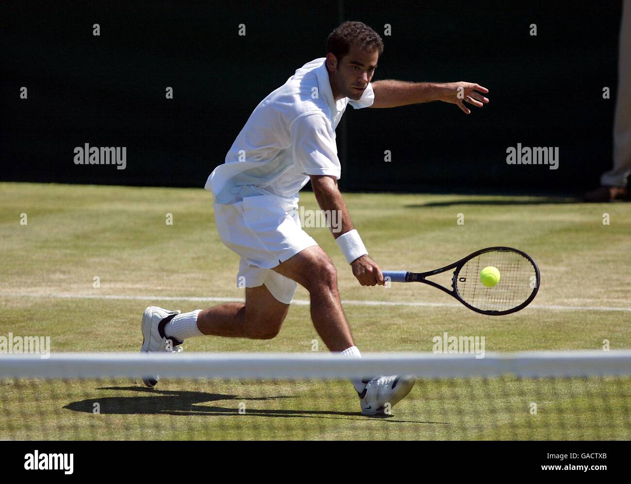 Pete Sampras lunges for a ball during his match with George Bastl Stock Photo