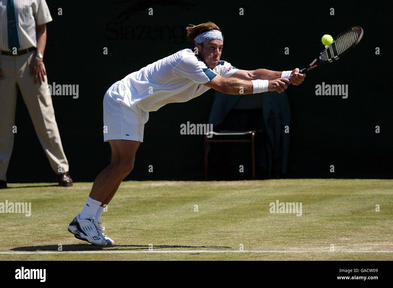 Tennis - Wimbledon 2002 - Second Round. George Bastl lunges for the ball on the base line against Pete Sampras Stock Photo