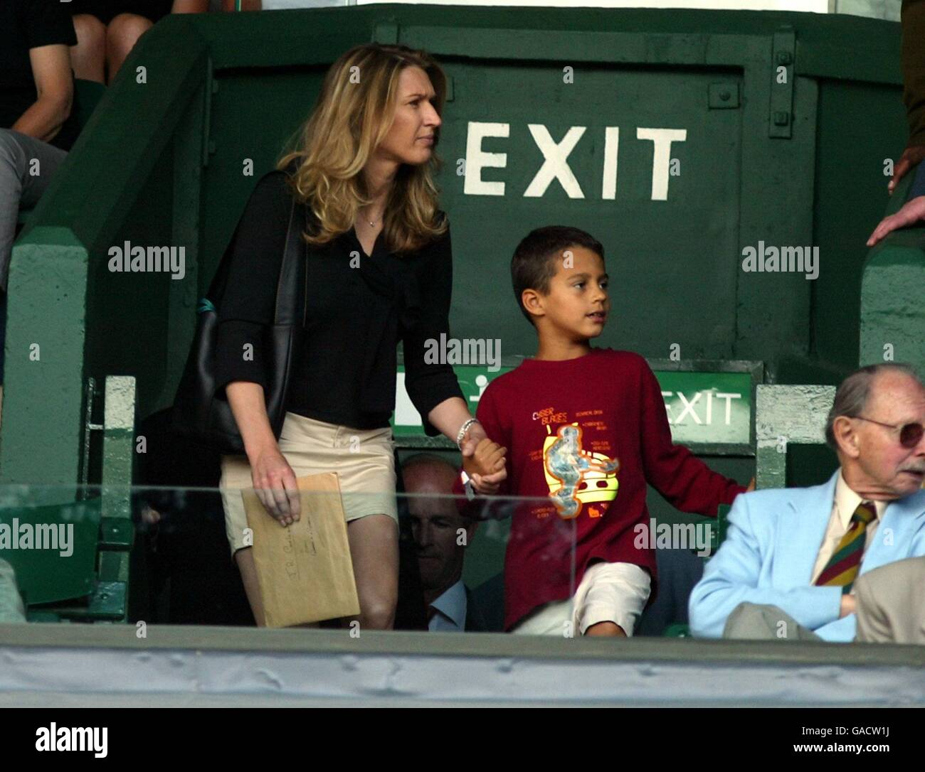 Tennis - Wimbledon 2002 - Second Round. Steffi Graf arrives with a young friend to watch her husband Andre Agassi play Stock Photo