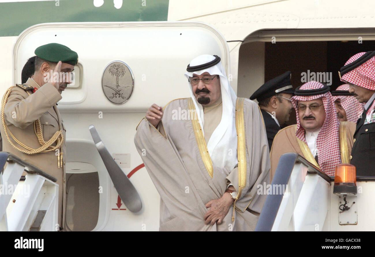 King Abdullah of Saudi Arabia (centre) steps from a plane at Heathrow airport for his state visit to Britain. Stock Photo