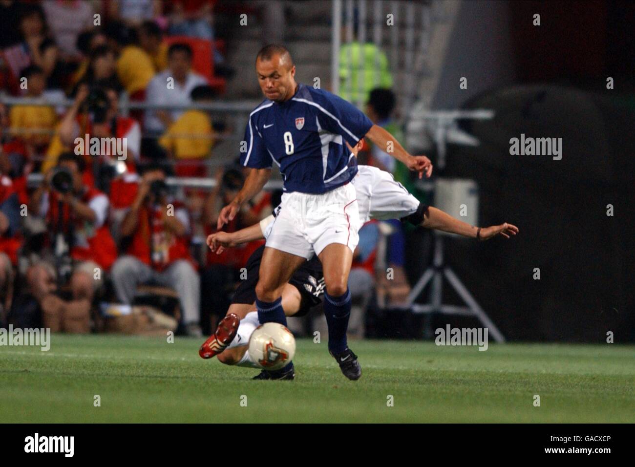 Soccer - FIFA World Cup 2002 - Quarter Final - Germany v USA. USA's Earnie Stewart is tackled from behind Stock Photo