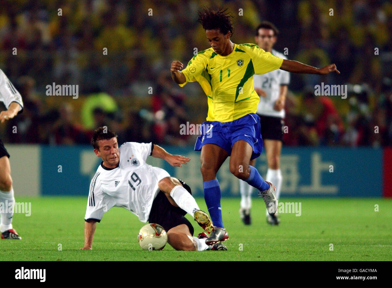 Soccer - FIFA World Cup 2002 - Final - Germany v Brazil. Germany's Bernd Schneider (l) wins the ball from Brazil's Ronaldinho (r) Stock Photo