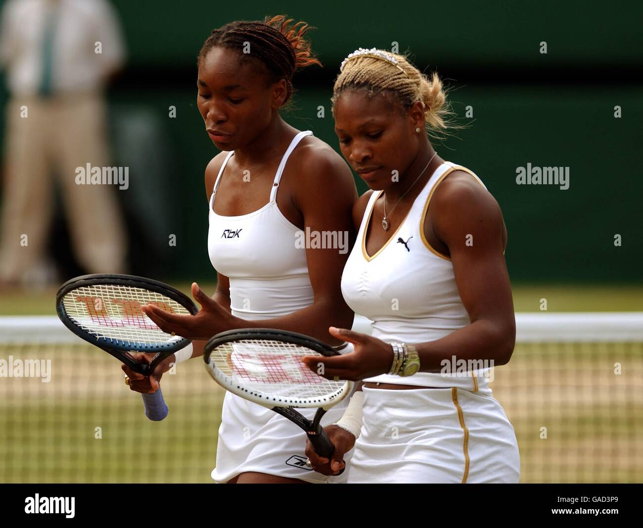 Tennis - Wimbledon 2002. Venus and Serena Williams together for their doubles match after their singles final earlier in the day Stock Photo