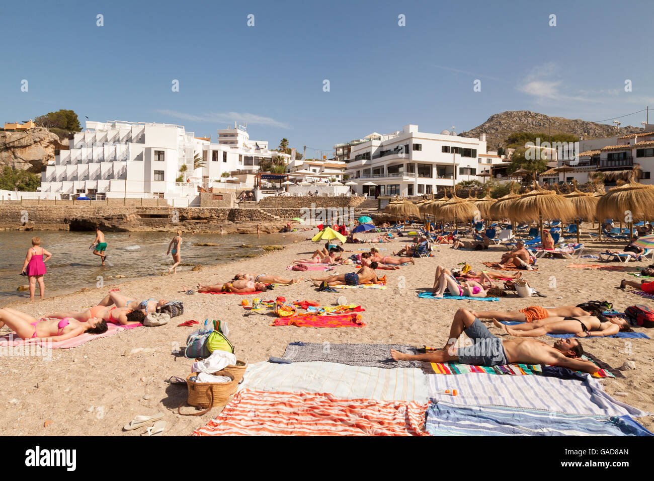Sunbathers sunbathing on the beach, Cala Sant Vincenc beach, north