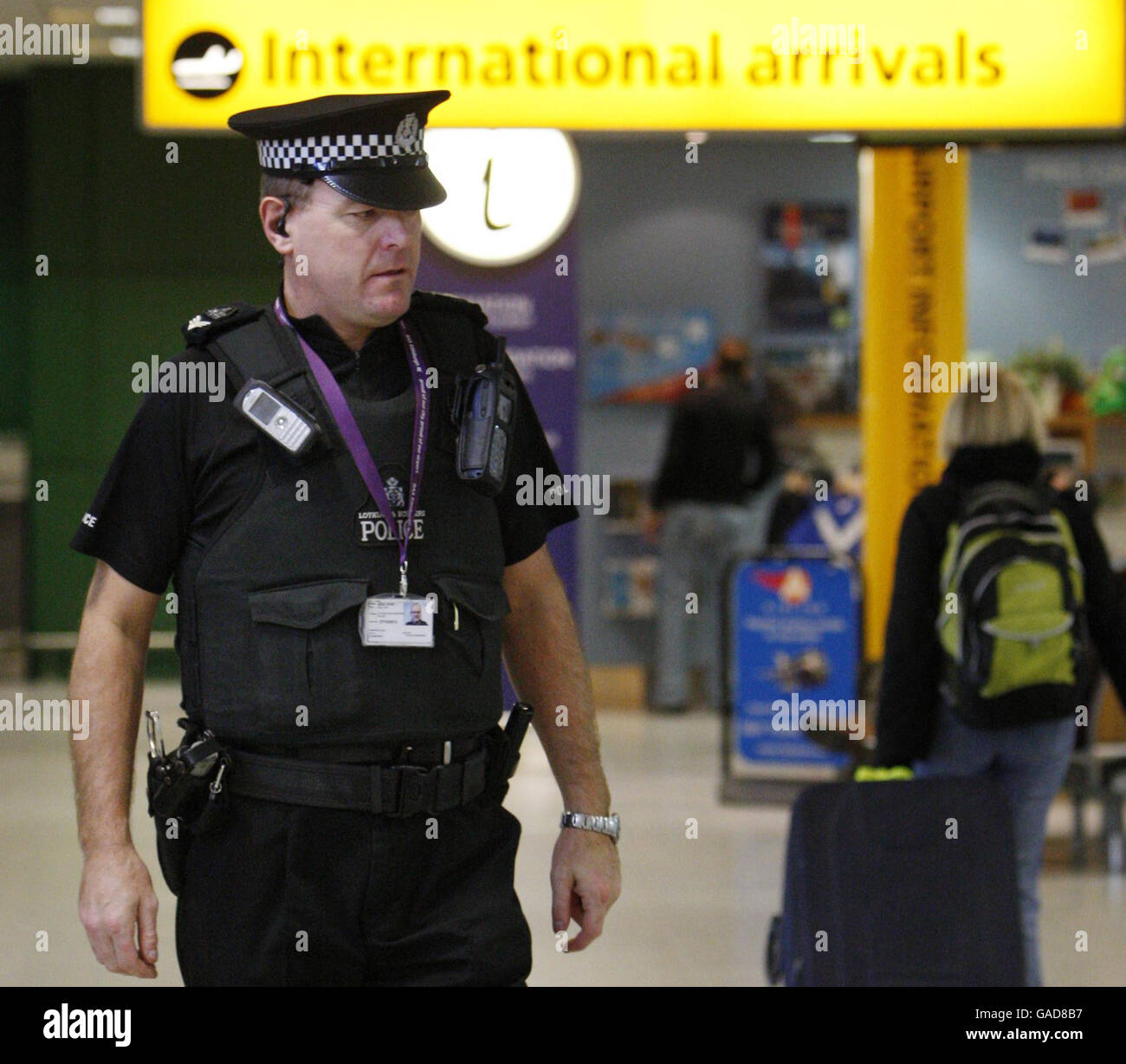 BAA results impacted by extra costs. A policeman walks through BAA's