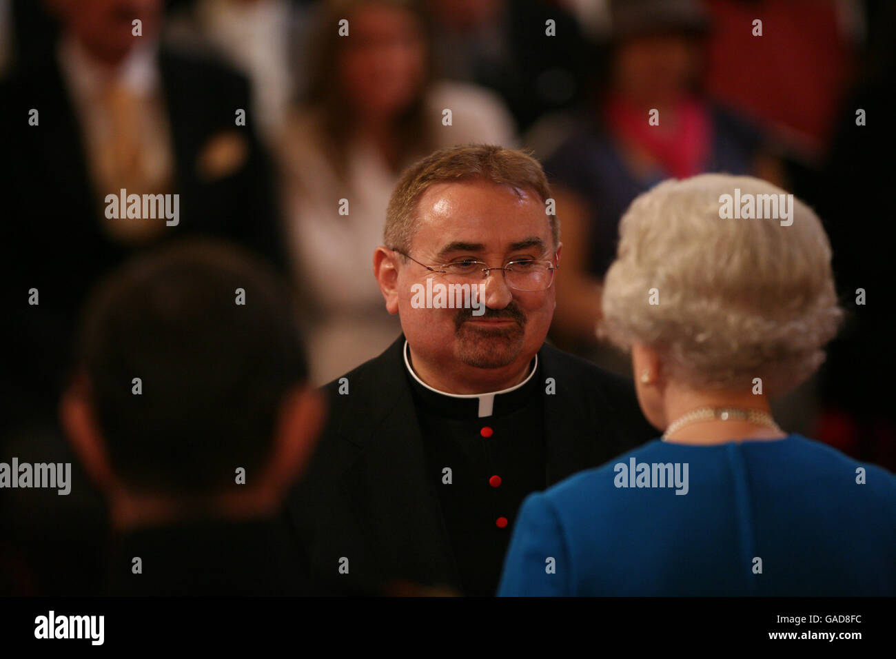 The Venerable Dr. Ian Young is made an MBE by The Queen at Buckingham Palace Stock Photo Alamy