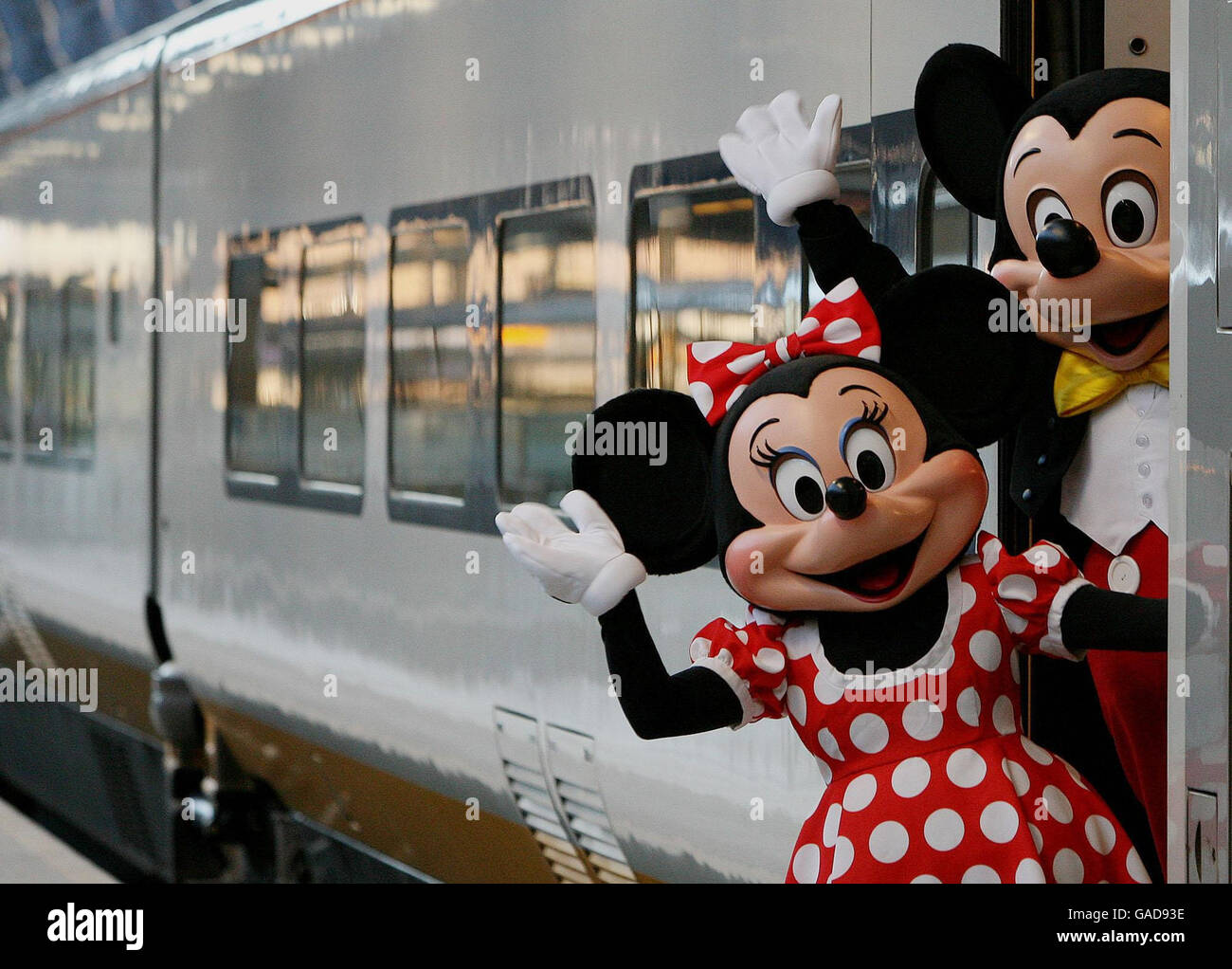 Mickey and Minnie Mouse wave goodbye as they board the first direct Eurostar train from St. Pancras Station to Disneyland Resort Paris. Stock Photo