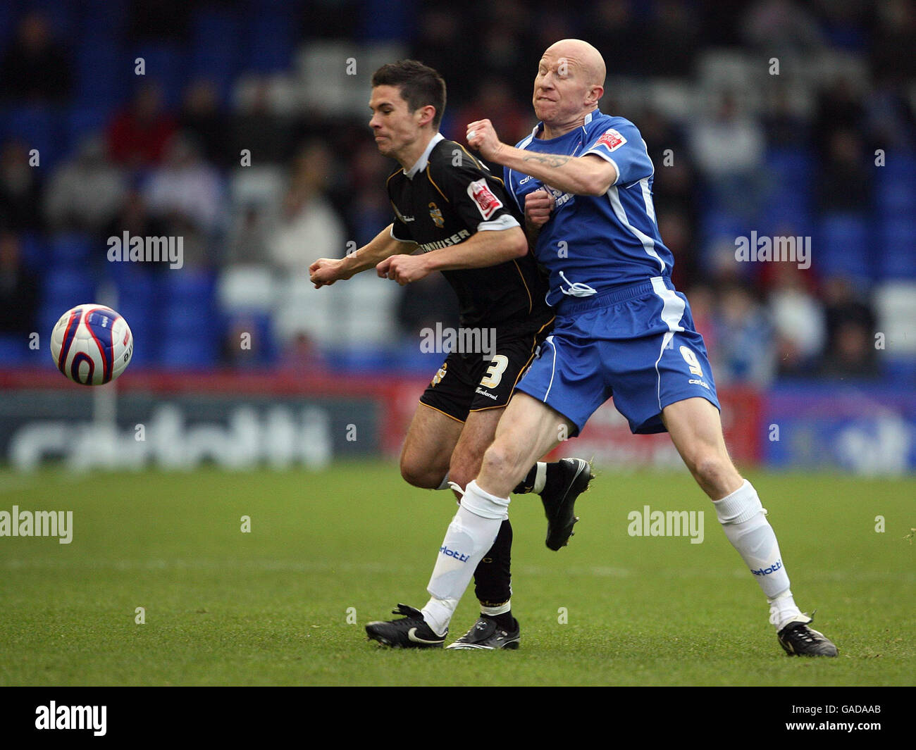 Oldham Athletic's Lee Hughes tussles with Port Vale's Jason Talbot during the Coca-Cola Football League One match at Boundary Park, Oldham. Stock Photo