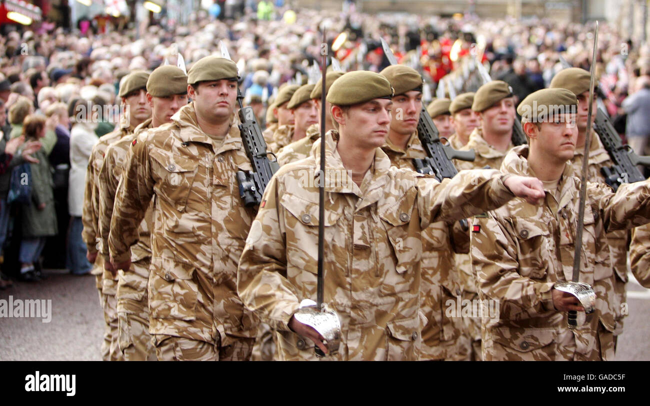 Members of the public gather to soldiers of the Royal Anglian