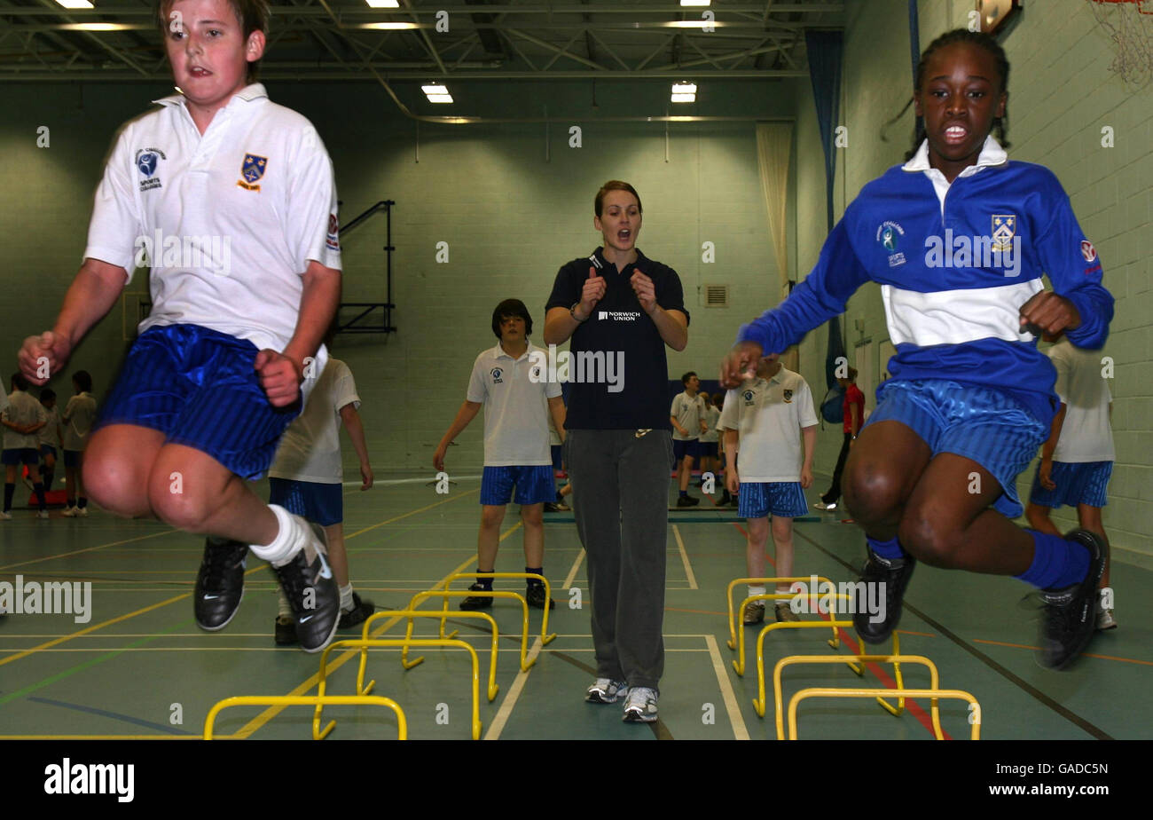 Great Britain's Kelly Sotherton the World Bronze medal-winning heptathlete watches children in the sports hall during a photocall at the Bishop Chaloner Catholic School, Sports College, Birmingham. Stock Photo