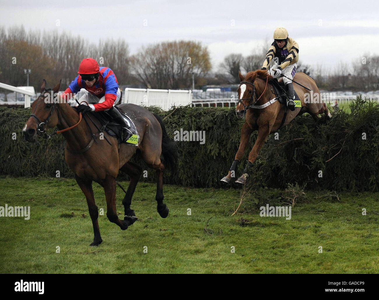 Jockey Sam Thomas and Mr Pointment (left) jump the last fence to win the totesport.com Becher Chase Handicap at Aintree Racecourse. Stock Photo