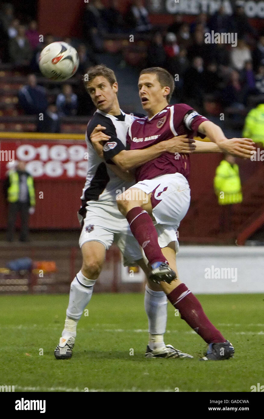 Hearts' Christophe Berra is held back by Gretna's Chris Innes during the Clydesdale Bank Scottish Premier League match at Fir Park, Motherwell. Stock Photo