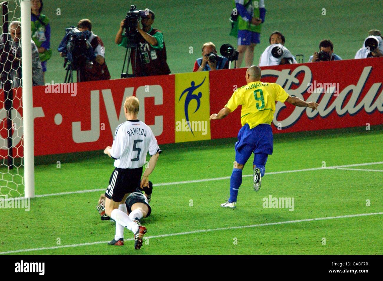 Soccer - FIFA World Cup 2002 - Final - Germany v Brazil. Brazil's Ronaldo (r) puts the ball past German goalkeeper Oliver Kahn (hidden) as Carsten Ramelow (l) looks on in despair Stock Photo