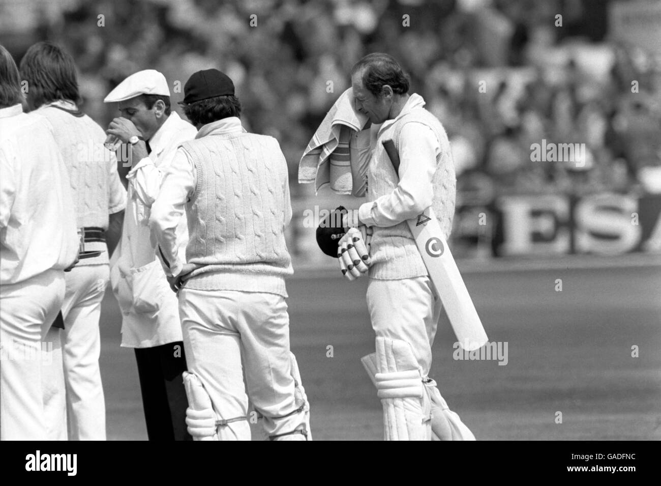 England's Geoff Boycott (r) wipes his brow after reaching his century in a mammoth innings of more than six hours Stock Photo