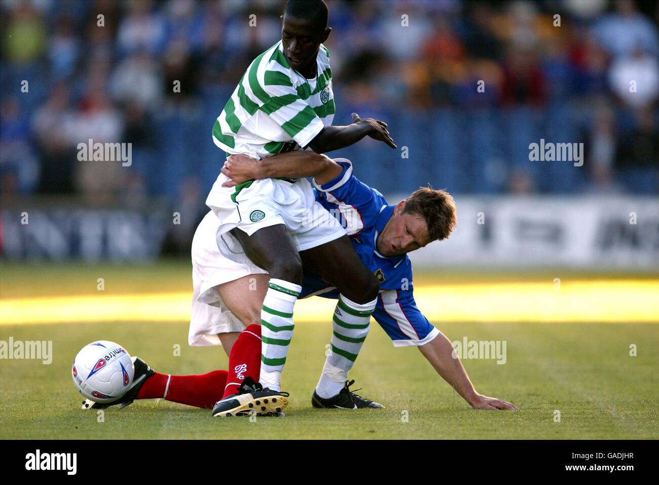 Portsmouth's Arjan de Zeeuw (r) and Celtic's Mohammed Sylla (l) battle for the ball Stock Photo