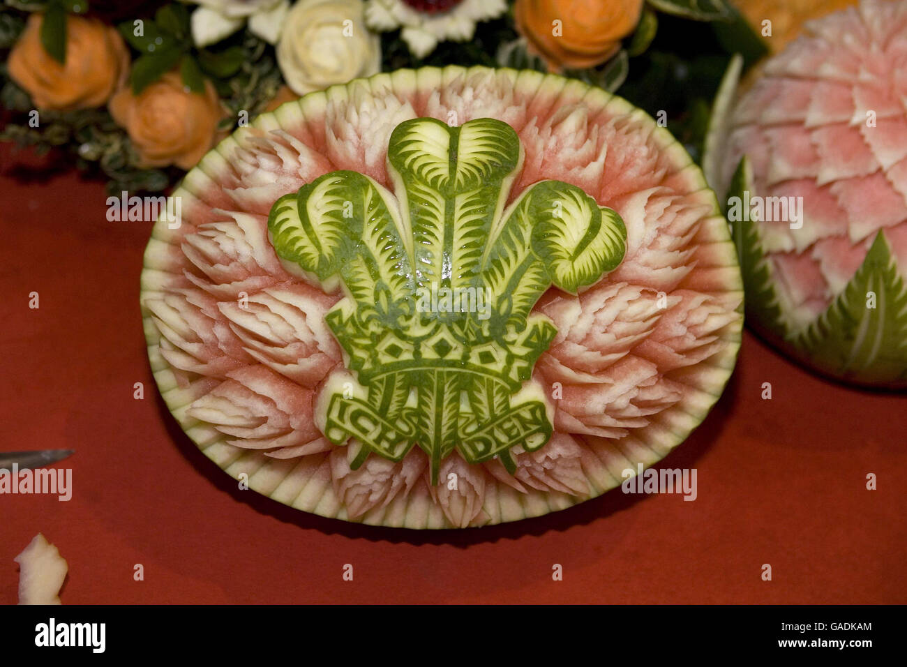 A melon has been cut in the design of the Prince of Wales' emblem the Fleur de Lys, as the Prince and the Duchess of Cornwall participate in Diwali preparations during a visit to Shri Swaminarayan temple in Neasden, northwest London. Stock Photo