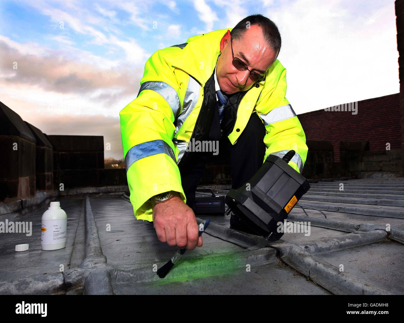 Graham Davies of SmartWater Technology applies a DNA impregnated water to the roof of St. Andrew's Church, Shifnal, Shropshire where the lead has been stolen for the third time in four weeks. Stock Photo