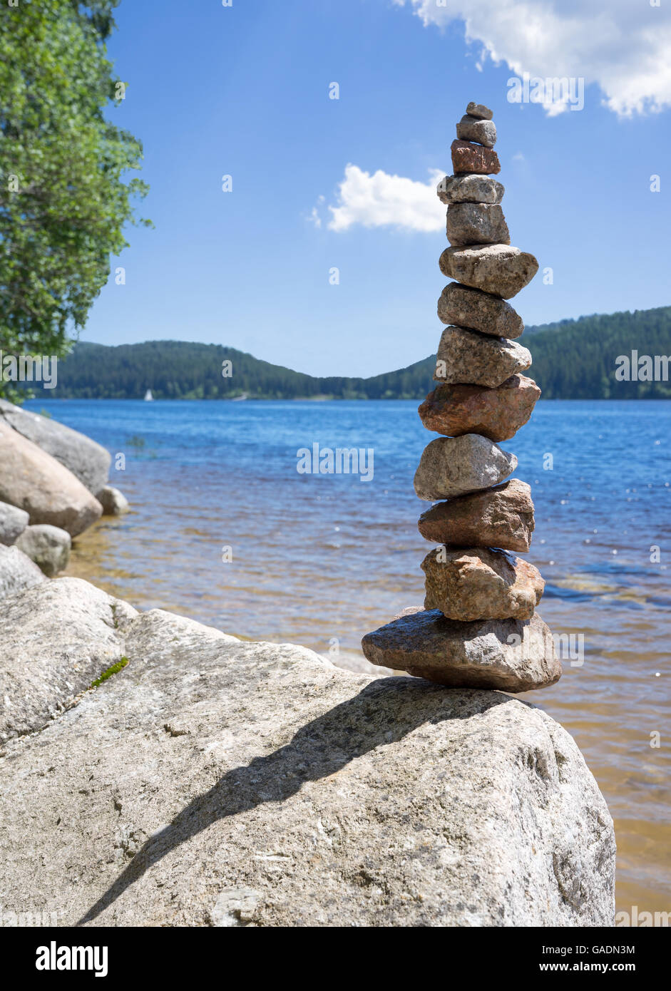 Rock balancing at a lake Stock Photo