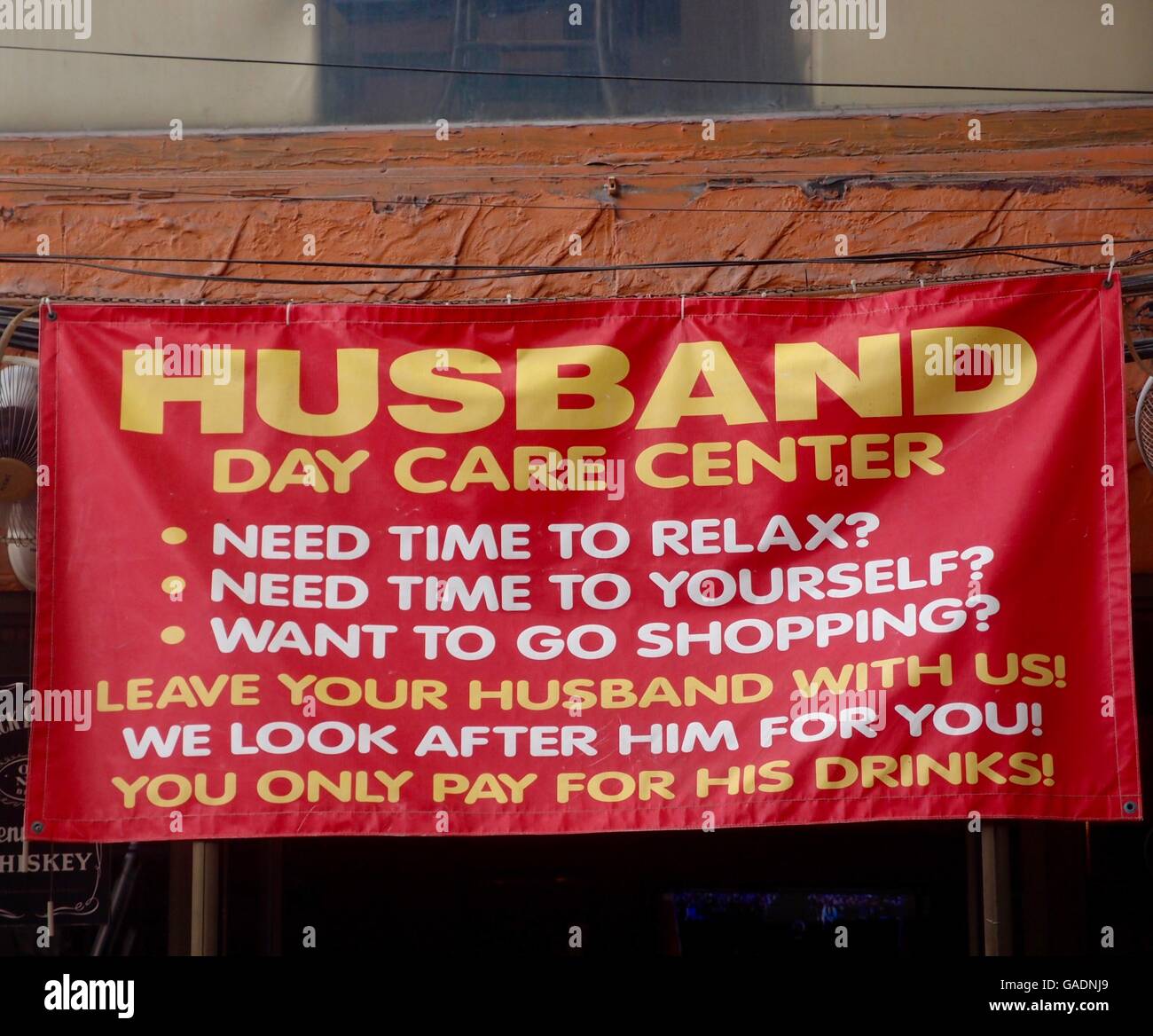 Sign with humorous text targeted to women who want the day off from their men. Stock Photo