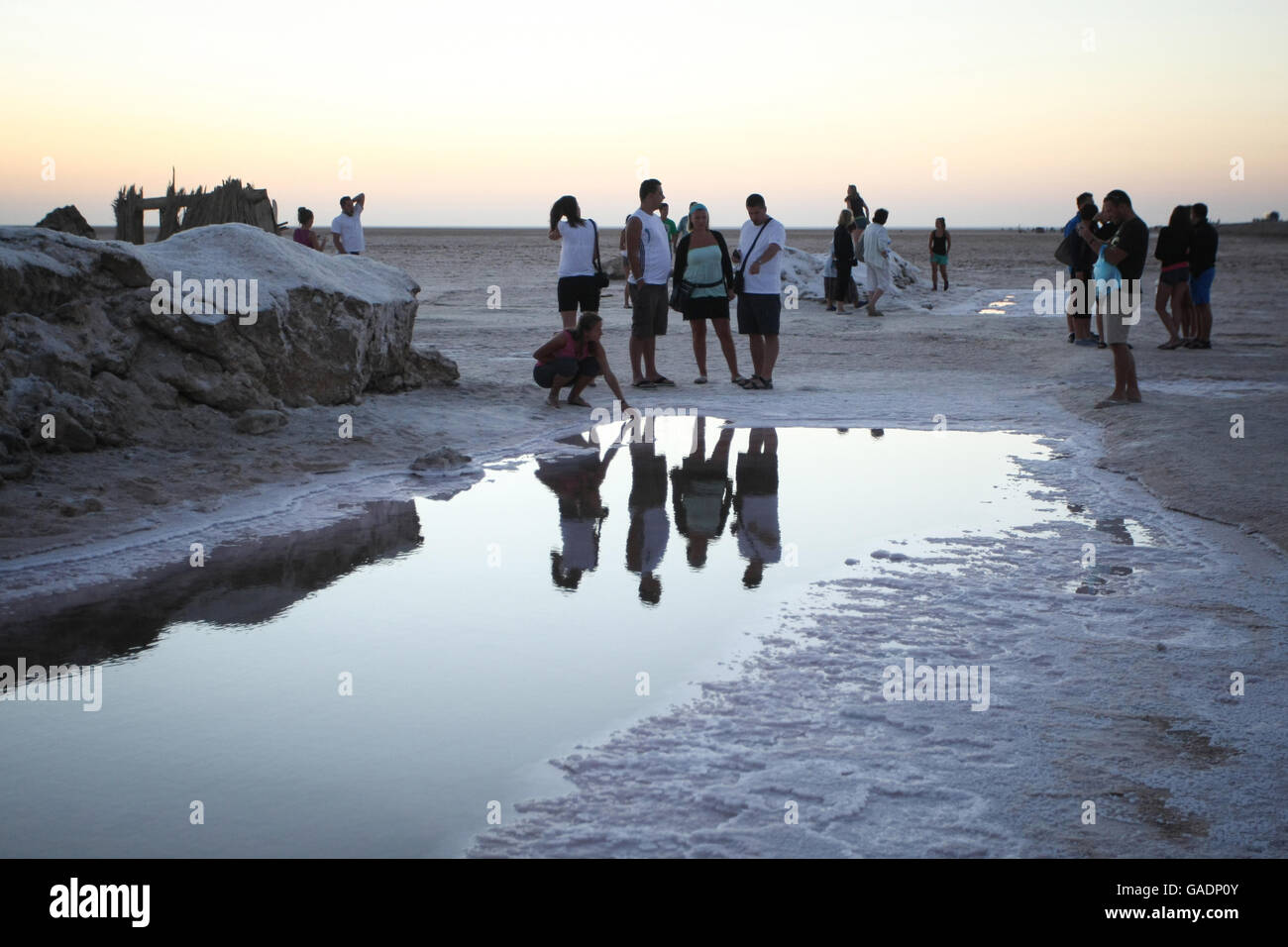 Tourists at Chott El Jerid, a large salt lake in southern Tunisia. Chott El Jerid is the largest salt pan of the Sahara. Stock Photo