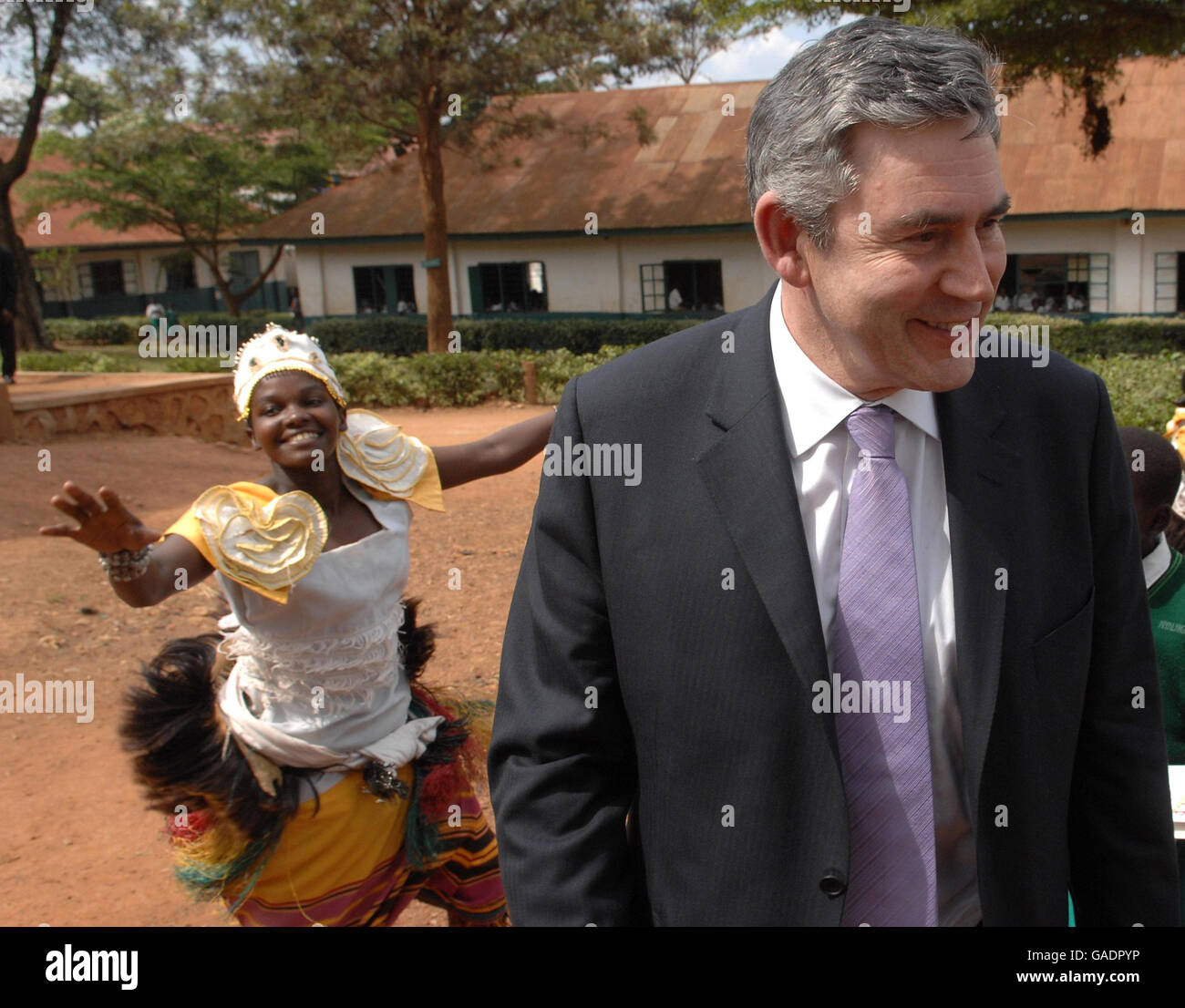 Prime Minister Gordon Brown is greeted by traditional music and dance at St Peter's Primary School in Nsambya, near the Ugandan capital Kampala, where the Commonwealth Heads of Government Meeting (CHOGM) is taking place. Stock Photo