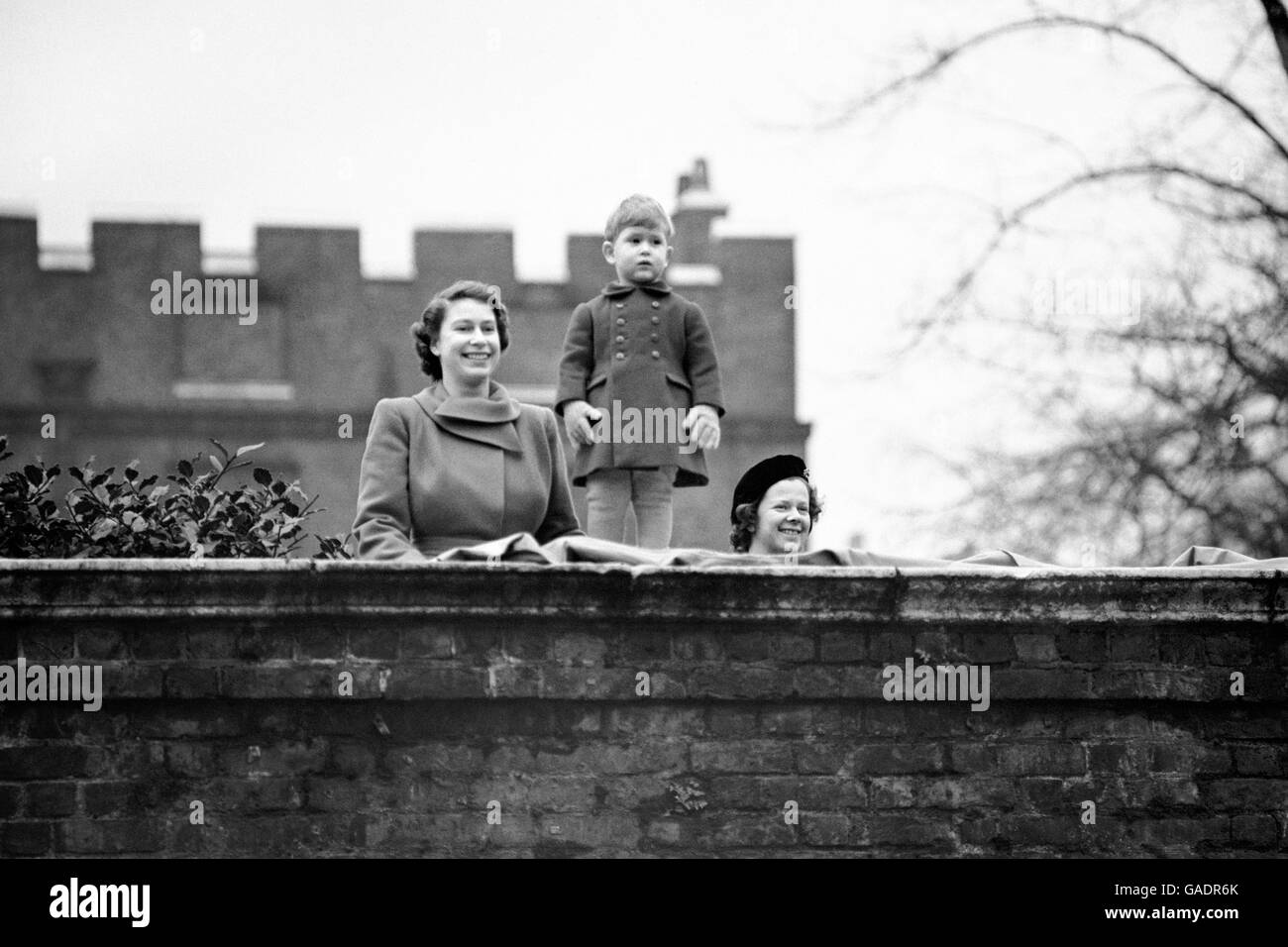 Princess Elizabeth with her two year old son Prince Charles, watch the procession from the wall of Clarence House, as Queen Juliana and Prince Bernhard of the Netherlands drive to the Guildhall. Stock Photo