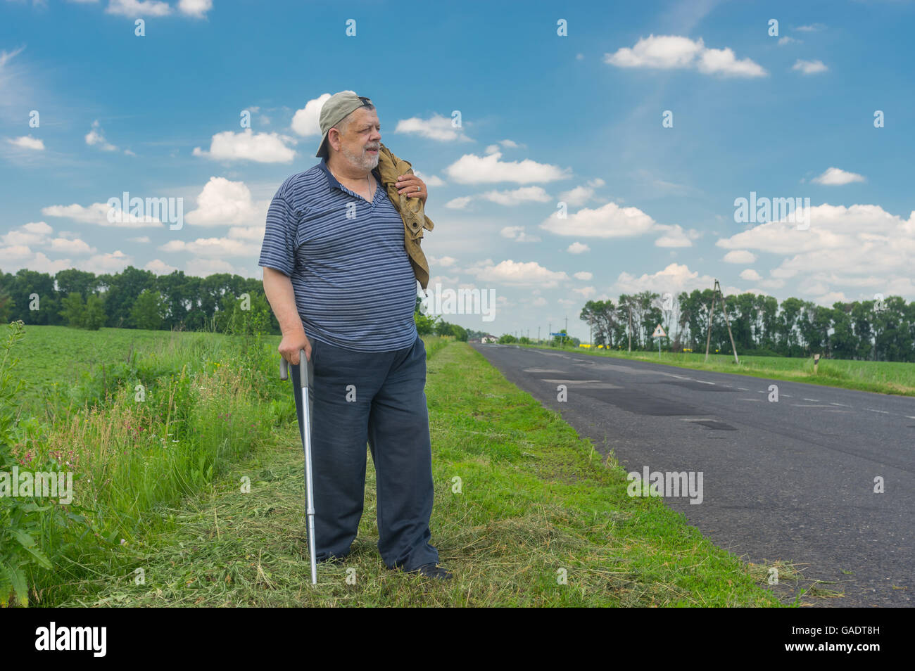 Old man with walking stick hi-res stock photography and images - Alamy