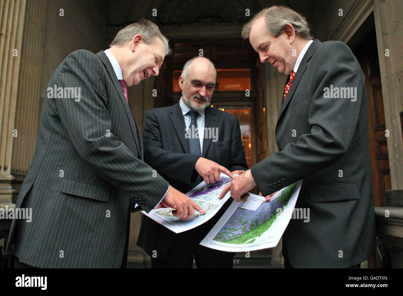 (Left to right) Scottish Minister for the Enviroment Michael Russell, Scottish Natural Heritage Chief Executive Ian Jardine and SNH Director of Policy Colin Galbraith, look at maps linking wildlife habitats across rural and urban areas before addressing a conference on the theme at Merchants' Hall, Edinburgh. Stock Photo