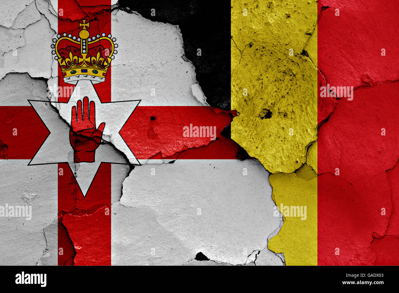 flags of Northern Ireland and Belgium painted on cracked wall Stock Photo