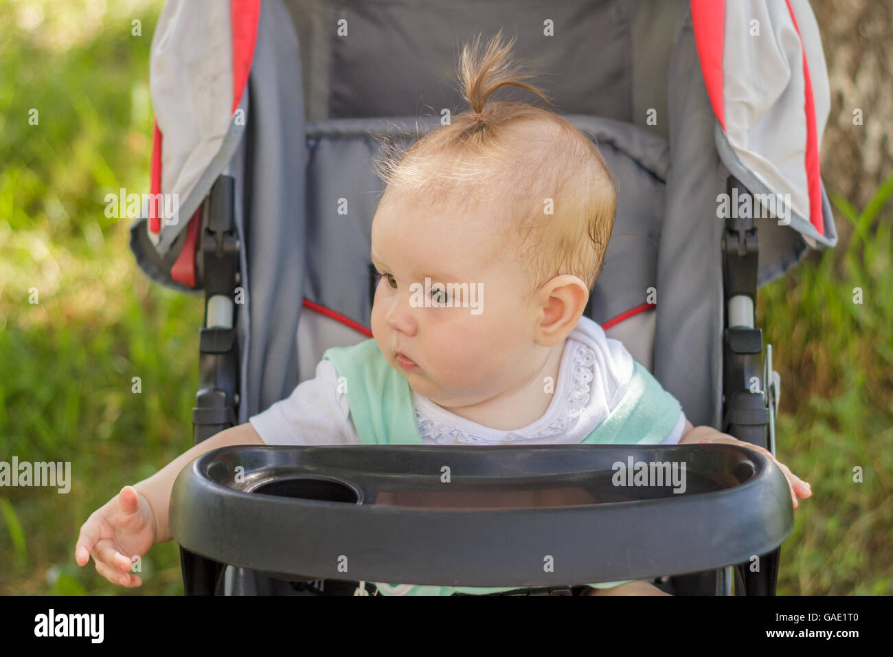 little girl sitting in a baby carriage Stock Photo - Alamy