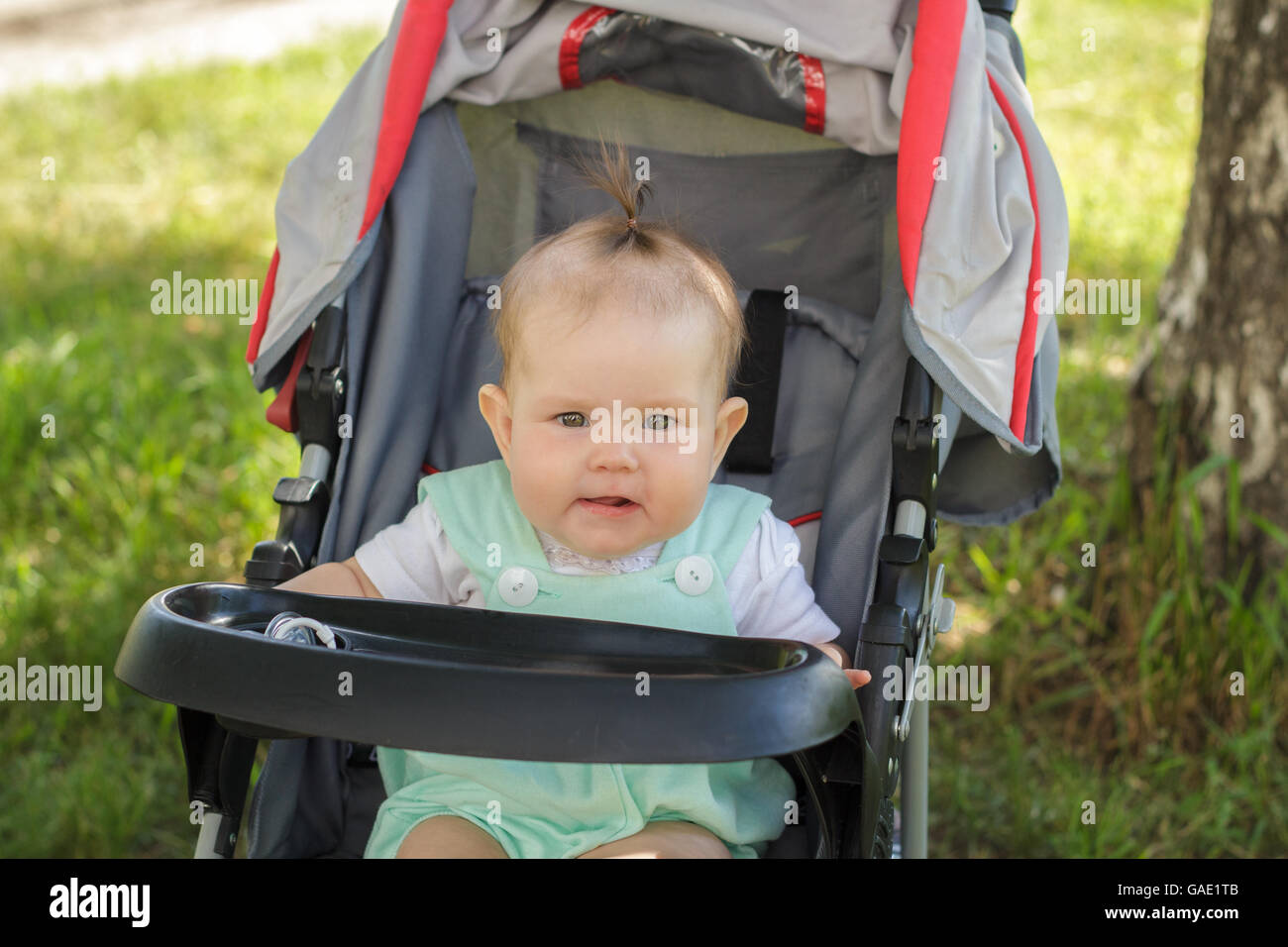 little girl sitting in a baby carriage Stock Photo - Alamy