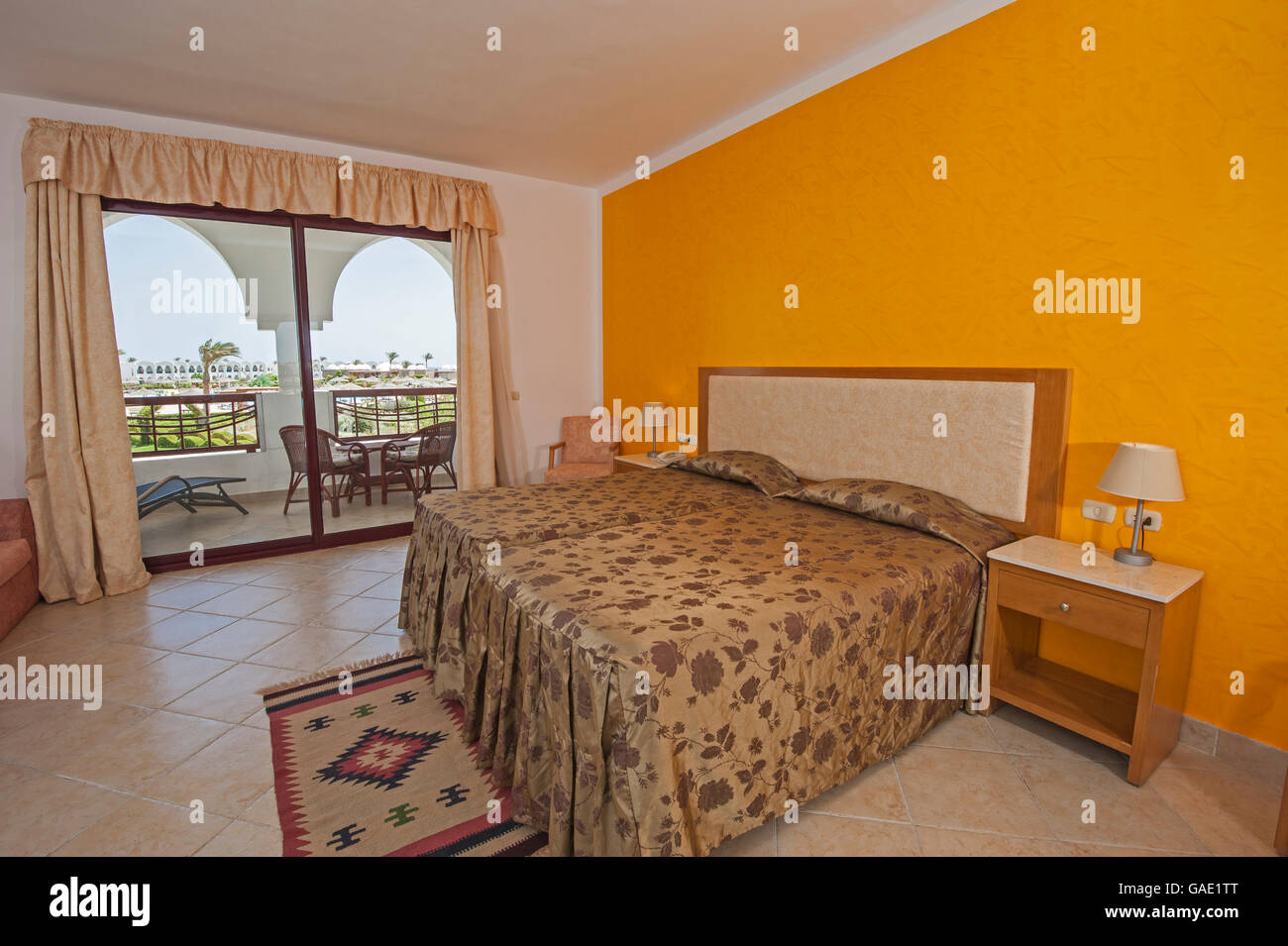Interior design of a luxury tropical hotel resort bedroom with balcony patio area Stock Photo