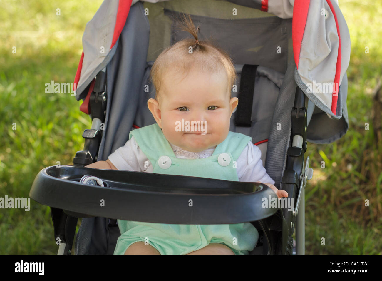 little girl sitting in a baby carriage Stock Photo - Alamy