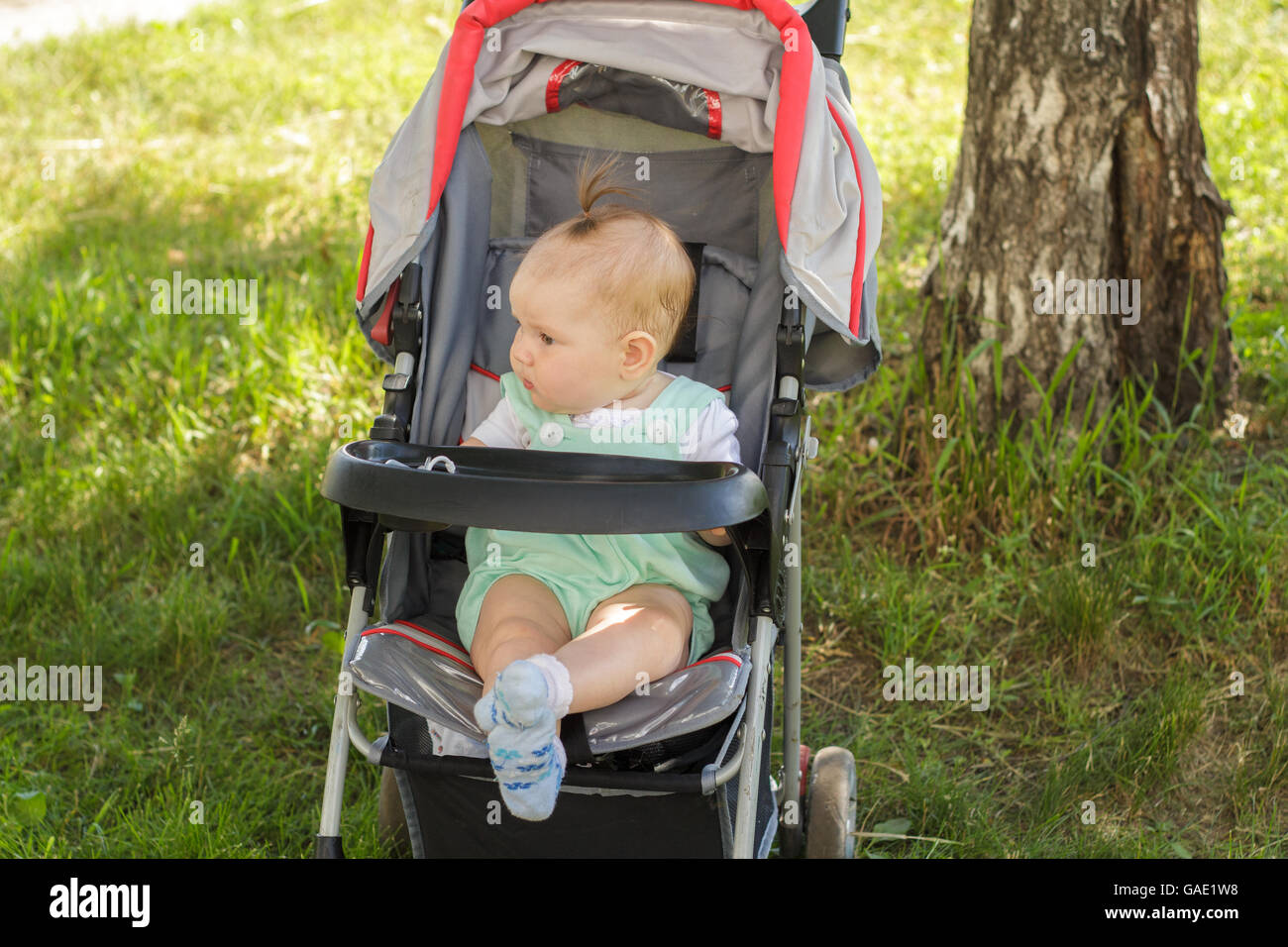 little girl sitting in a baby carriage Stock Photo - Alamy
