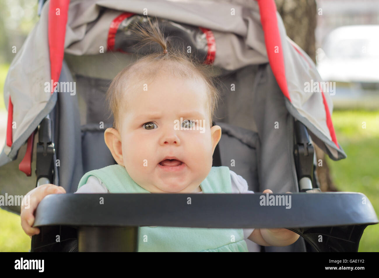 little girl sitting in a baby carriage Stock Photo - Alamy