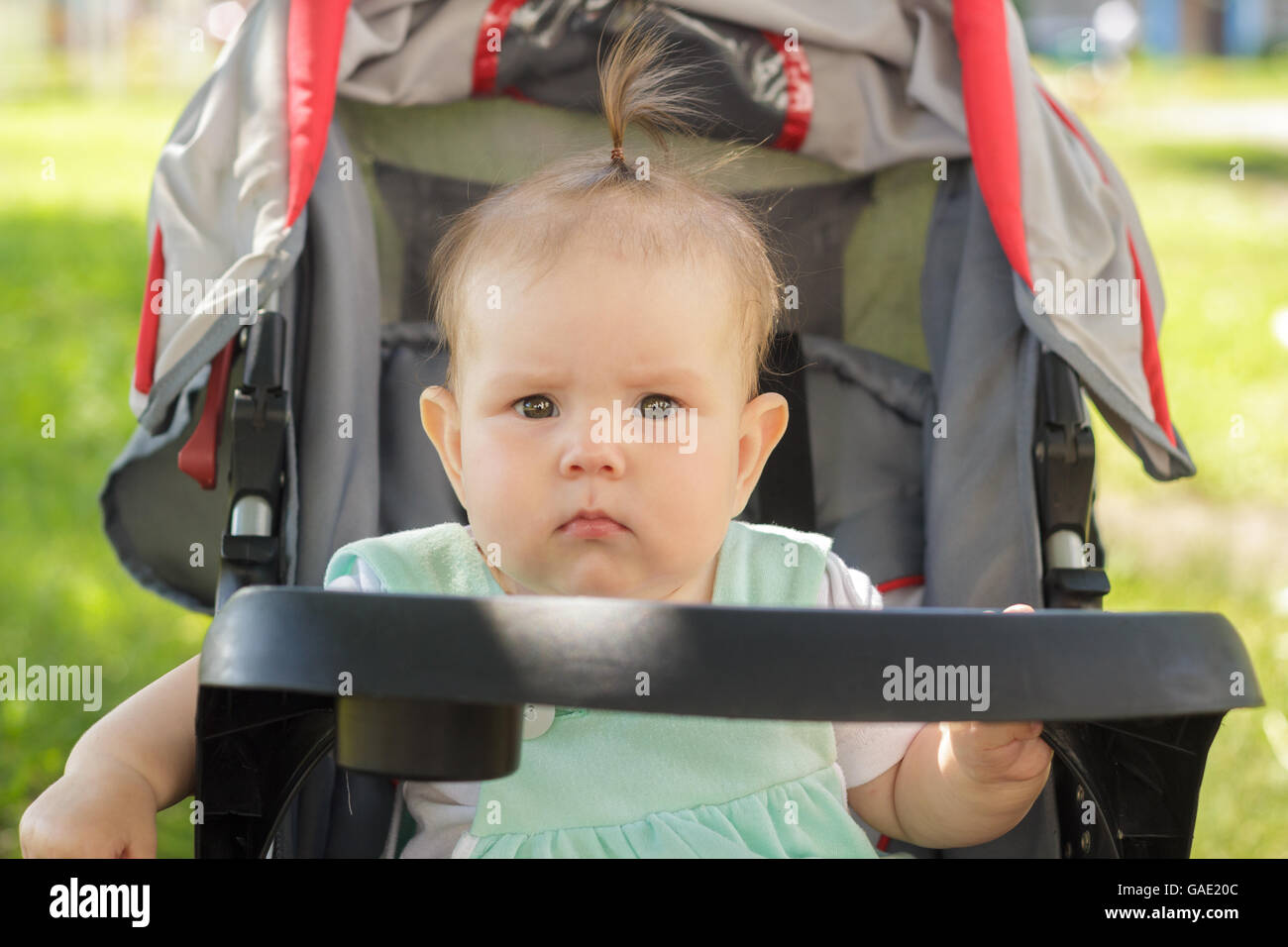 little girl sitting in a baby carriage Stock Photo - Alamy