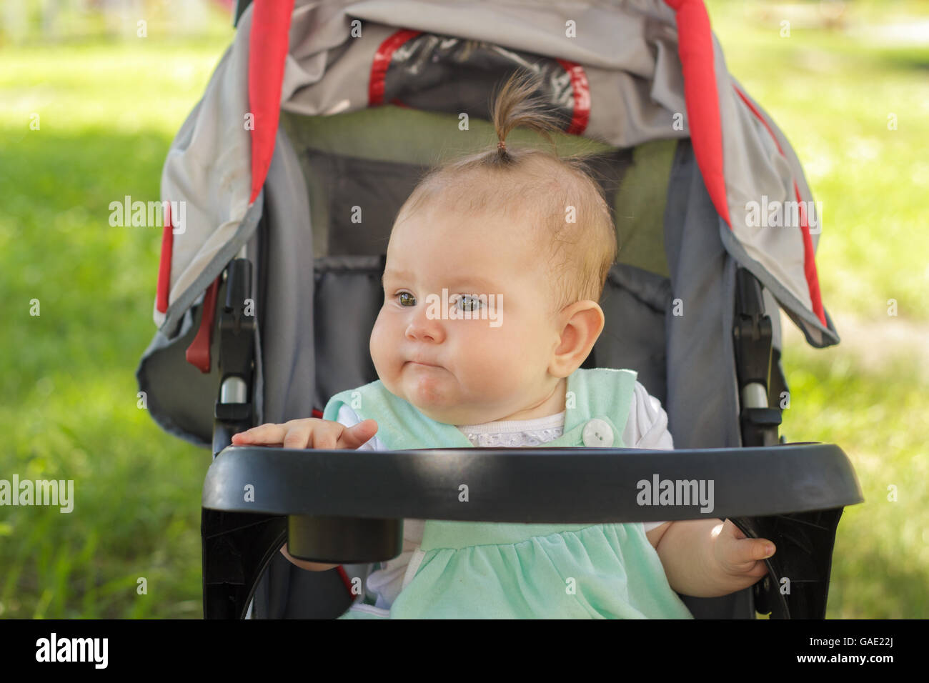 little girl sitting in a baby carriage Stock Photo - Alamy