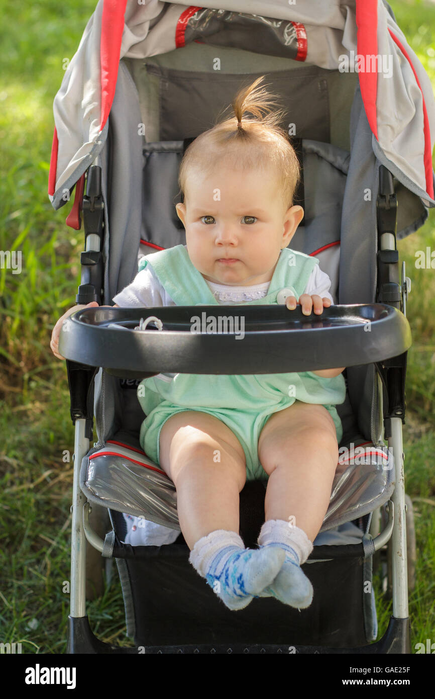 little girl sitting in a baby carriage Stock Photo - Alamy