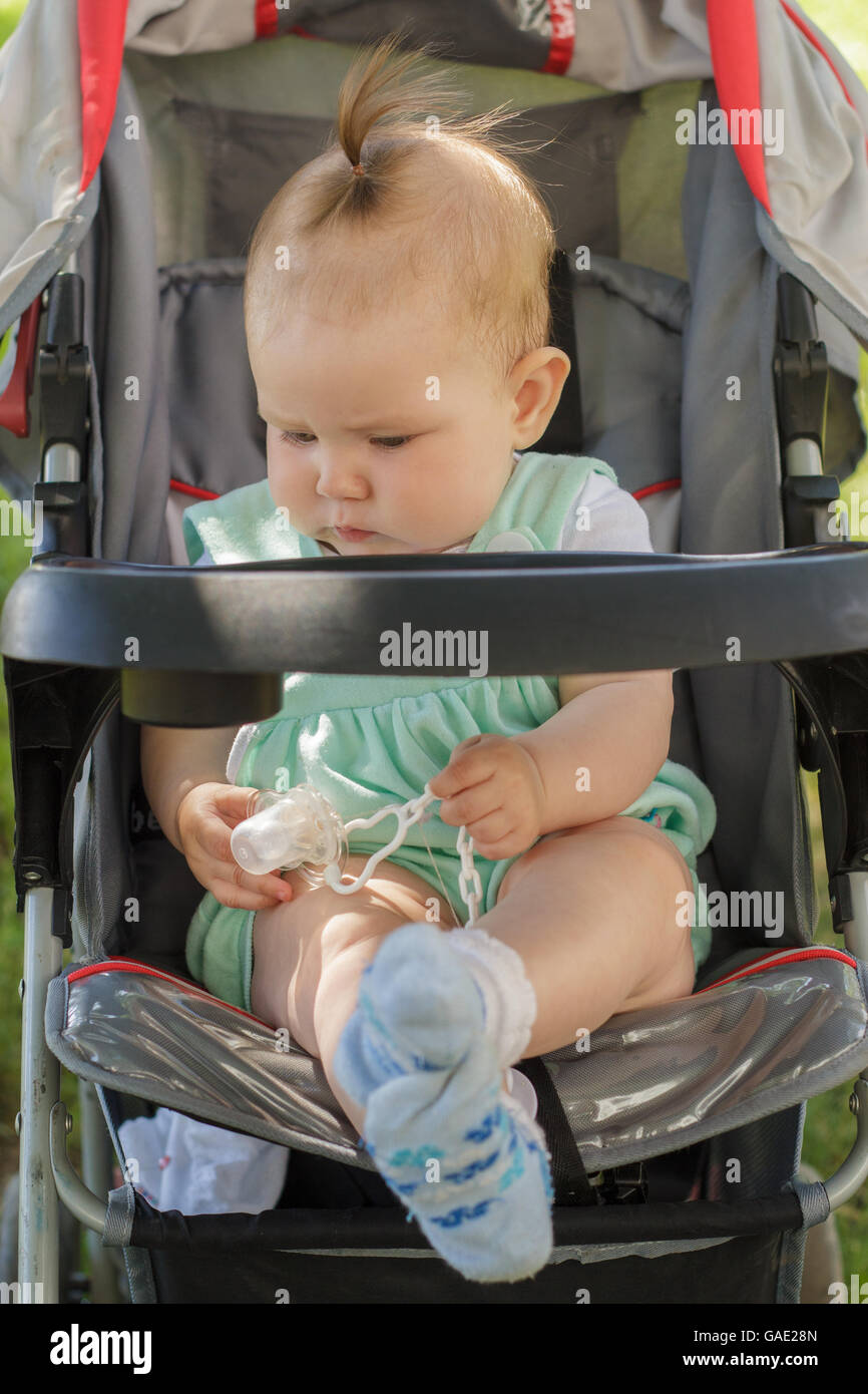little girl sitting in a baby carriage Stock Photo - Alamy