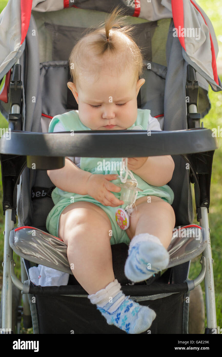 little girl sitting in a baby carriage Stock Photo - Alamy