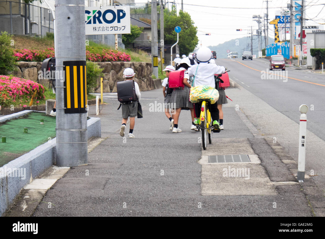 Schoolchildren walking and cycling home from school. Stock Photo