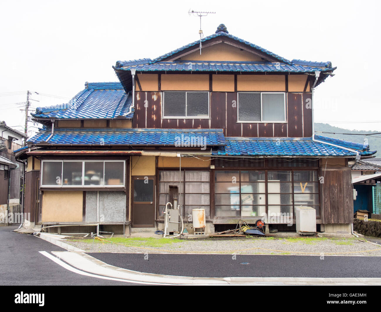 Traditional Japanese timber house with blue roof tiles. Stock Photo
