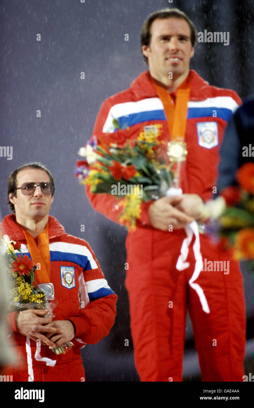 American Steven Mahr (l) looks on with his silver medal as his twin brother Phillip receives the Gold medal for the Slalom. Stock Photo