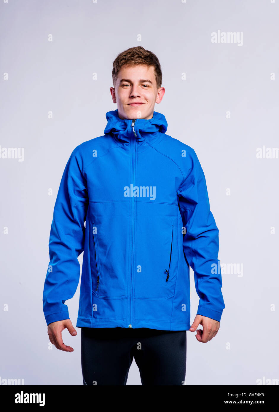Boy in blue sports jacket, young man, studio shot Stock Photo Alamy