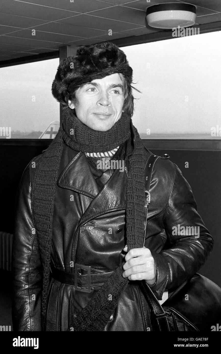Rudolf Nureyev, the ballet dancer, was well protected from the winter weather and the fuel shortage when he left London Airport. He is seen at Heathrow wearing a fake fur cap, leather coat and knee-length boots, with a scarf round his neck. He weas flying to Paris for a ballet rehearsal; then he goes to Milan for a ballet appearance. Stock Photo